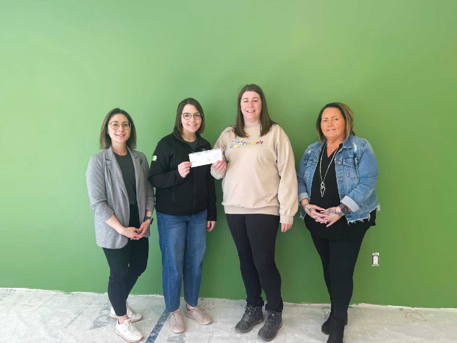 From left are Teshia Nosterud and Brittany Glasser with Moosomin Pharmasave making a $15,000 donation to Jill Joes and Terri Lowe with Playfair Daycare in Moosomin.